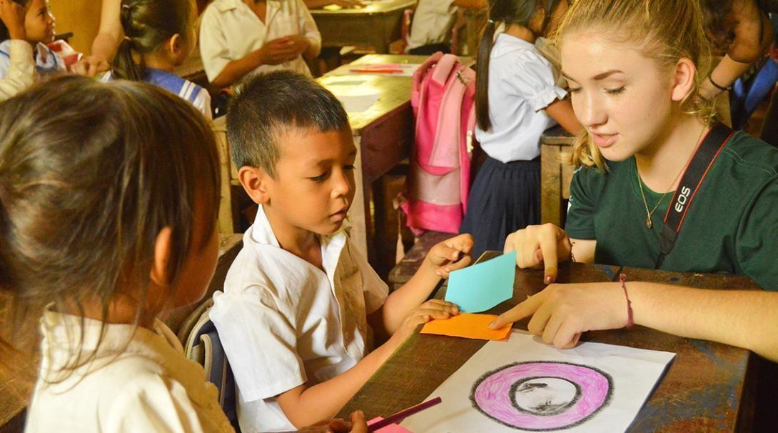 Volunteer helping with an art class