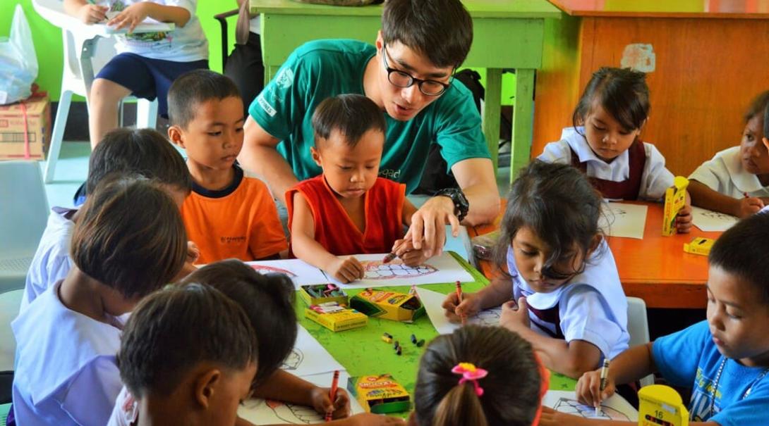 Do volunteer work with children in the Philippines