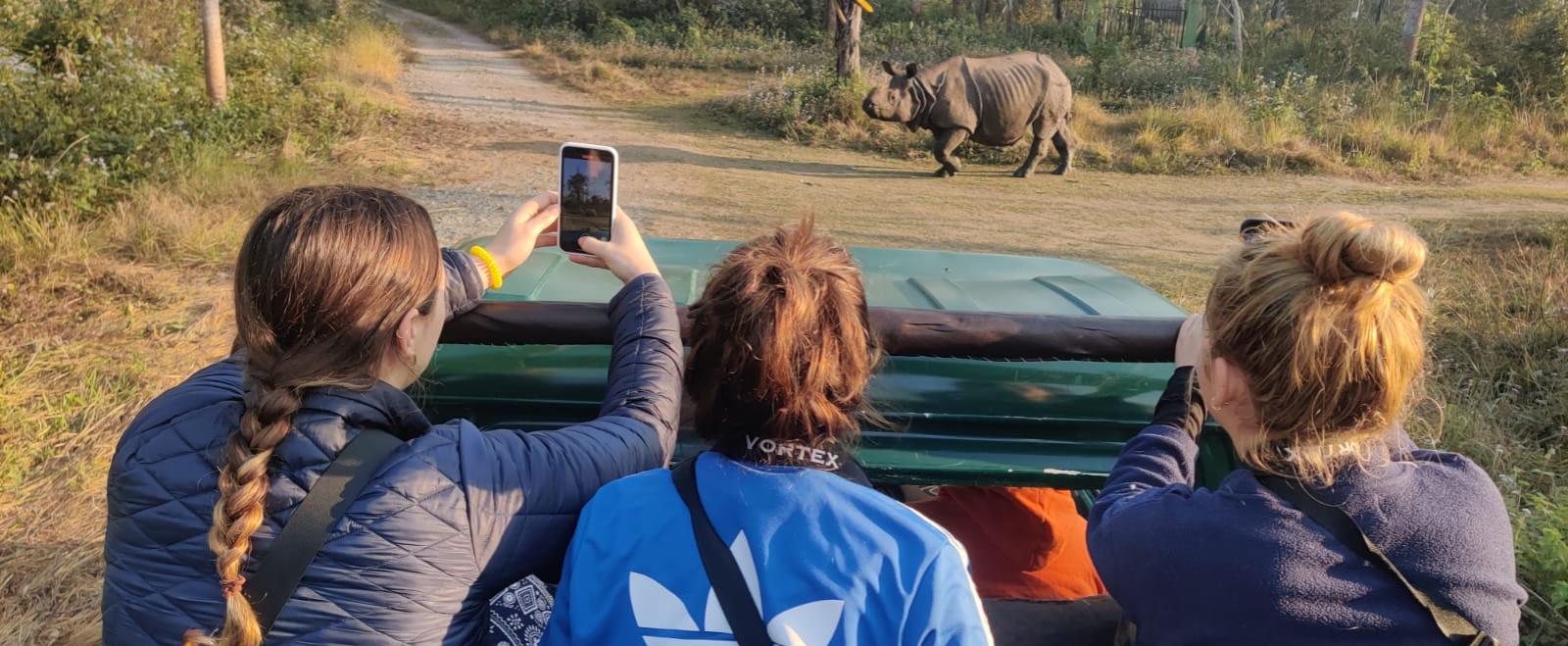 A group of Conservation volunteers spot a rhino in Chitwan, Nepal