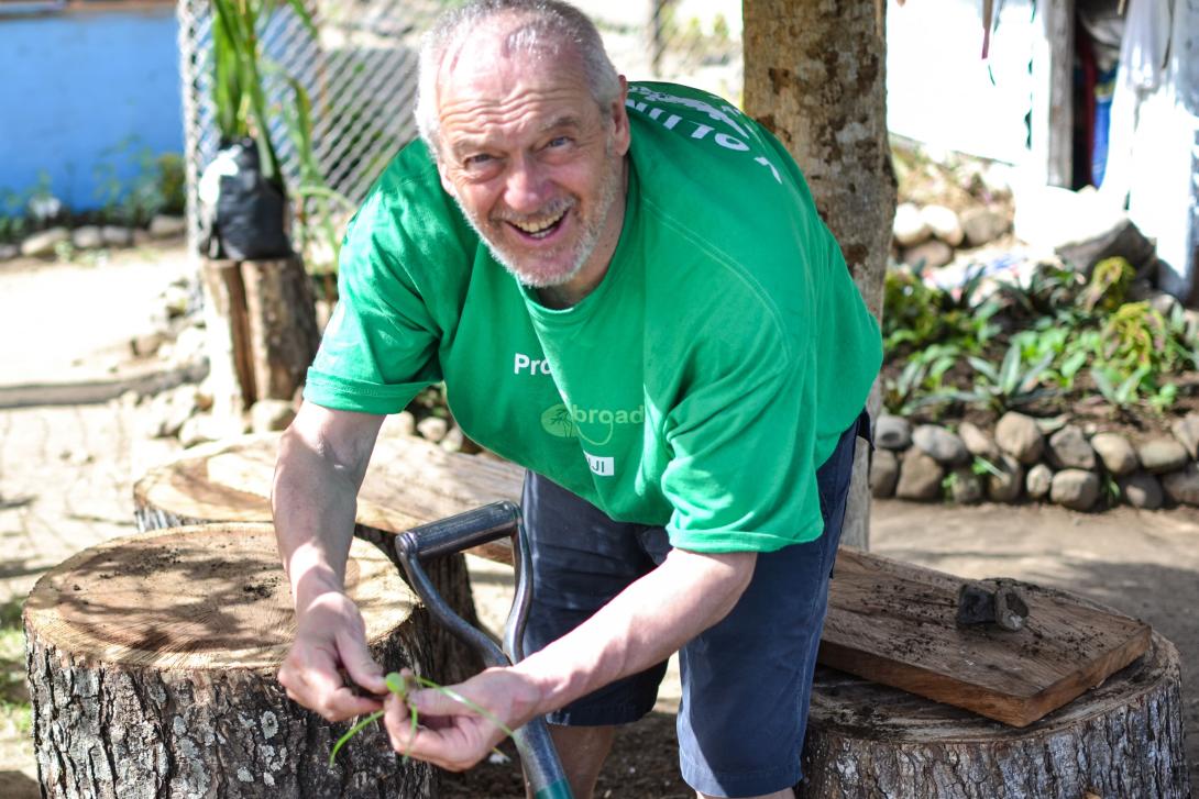 Older Projects Abroad grown-up doing gardening work in the village greenhouse in Fiji