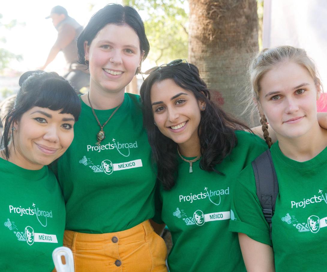 A group of volunteers in Mexico take a photo together before participating in a feeding programme.