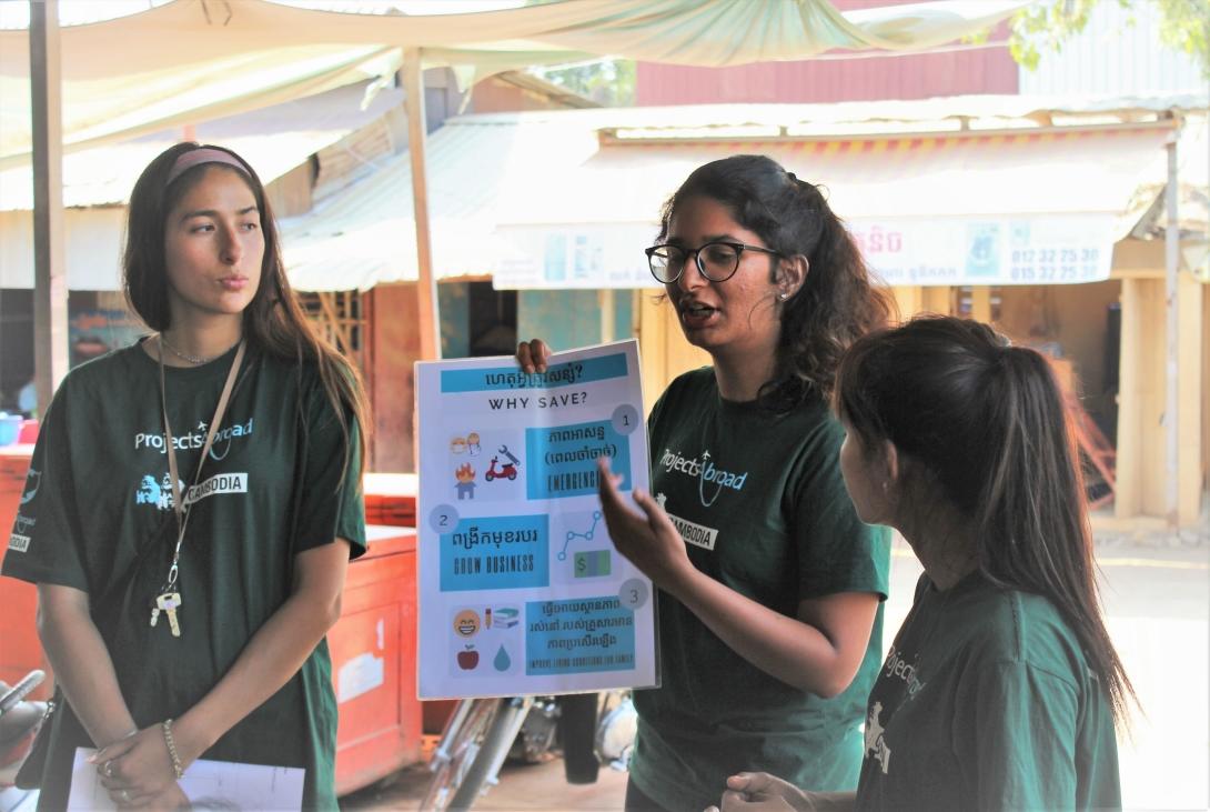 A Micro-finance volunteer abroad gives a presentation on savings to beneficiaries of the project in Cambodia