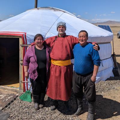 Older volunteer Stefan with his host parents in Mongolia