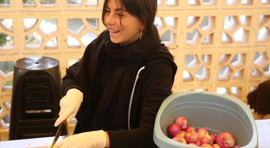 Volunteer cutting fruit at an outreach event