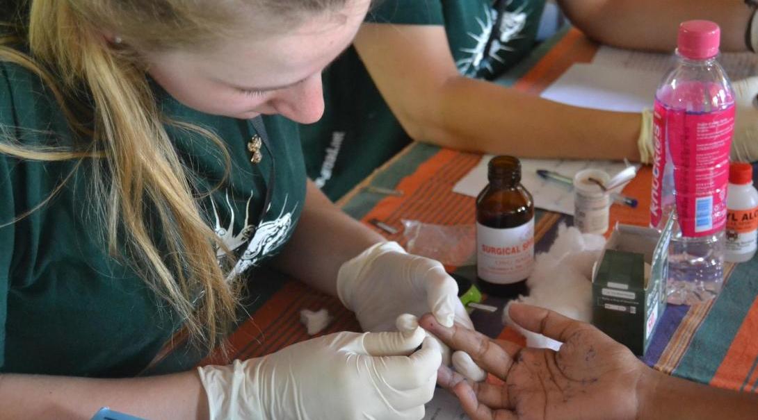 A Medical intern abroad doing a health check