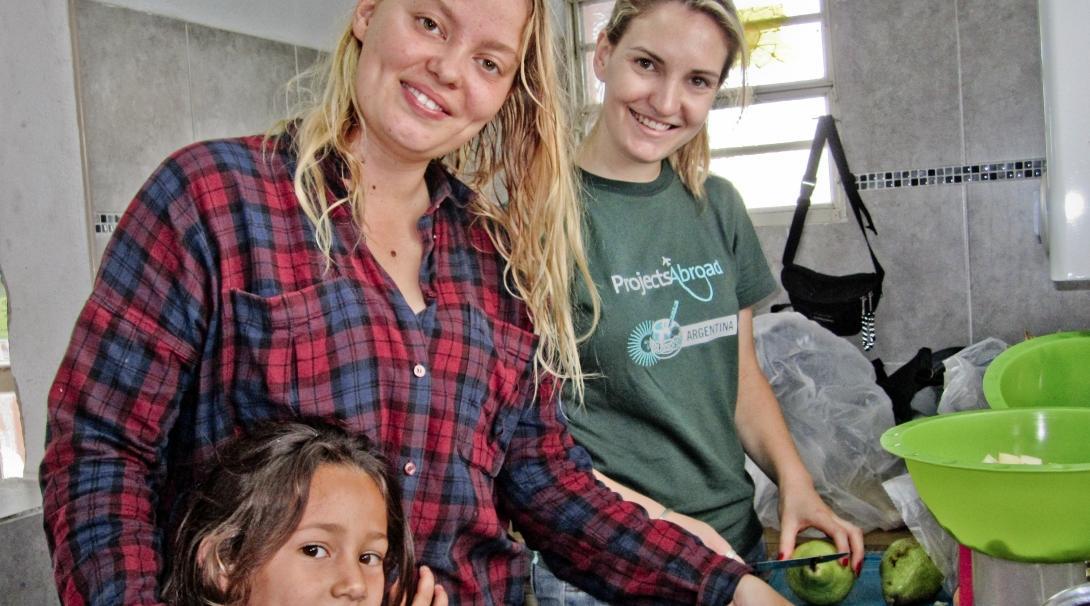 Projects Abroad volunteer working with children in Argentina prepares fruit in dining halls during a Childcare project.