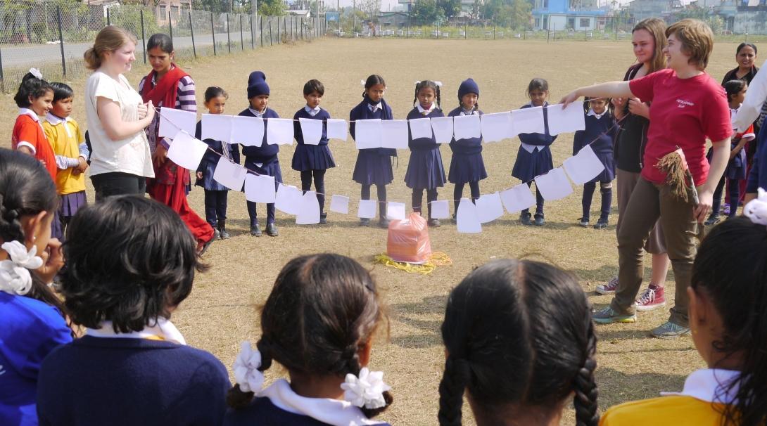 Projects Abroad volunteers working with children in Nepal are demonstrating how to brush your teeth in a school Childcare project.