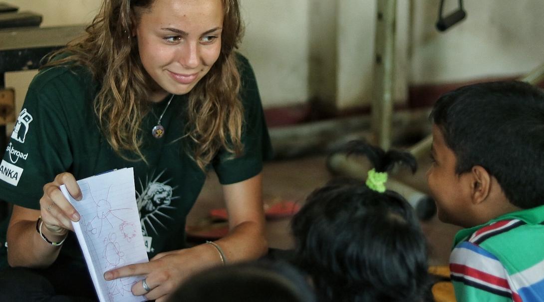 Projects Abroad volunteer with children in Sri Lanka teaches English to young children at her Childcare placement.