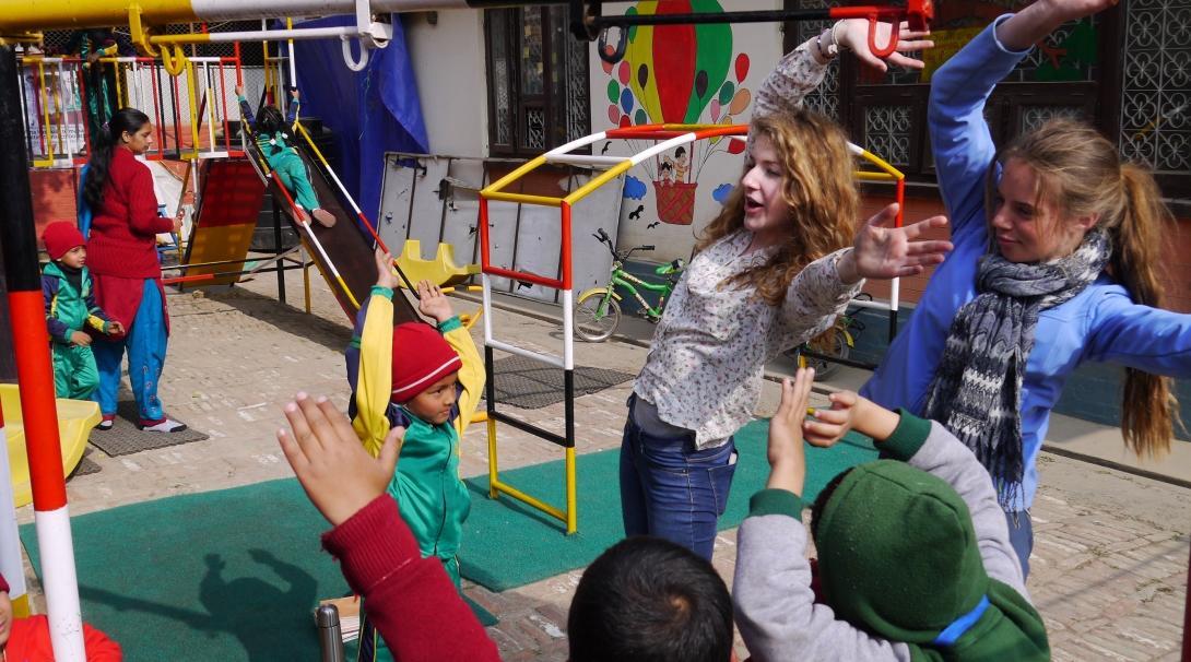 As part of community work in Nepal, Projects Abroad volunteers on a group trip lead an activity on the playground.    