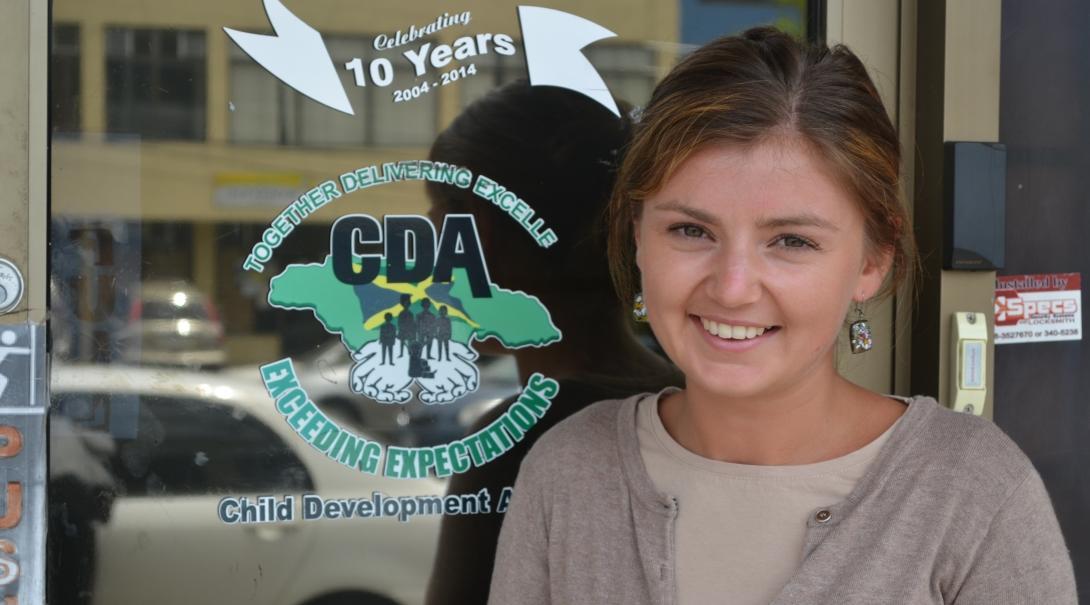 Female Childcare and Psychology worker is standing outside the Child Development Agency in Jamaica during an internship placement. 