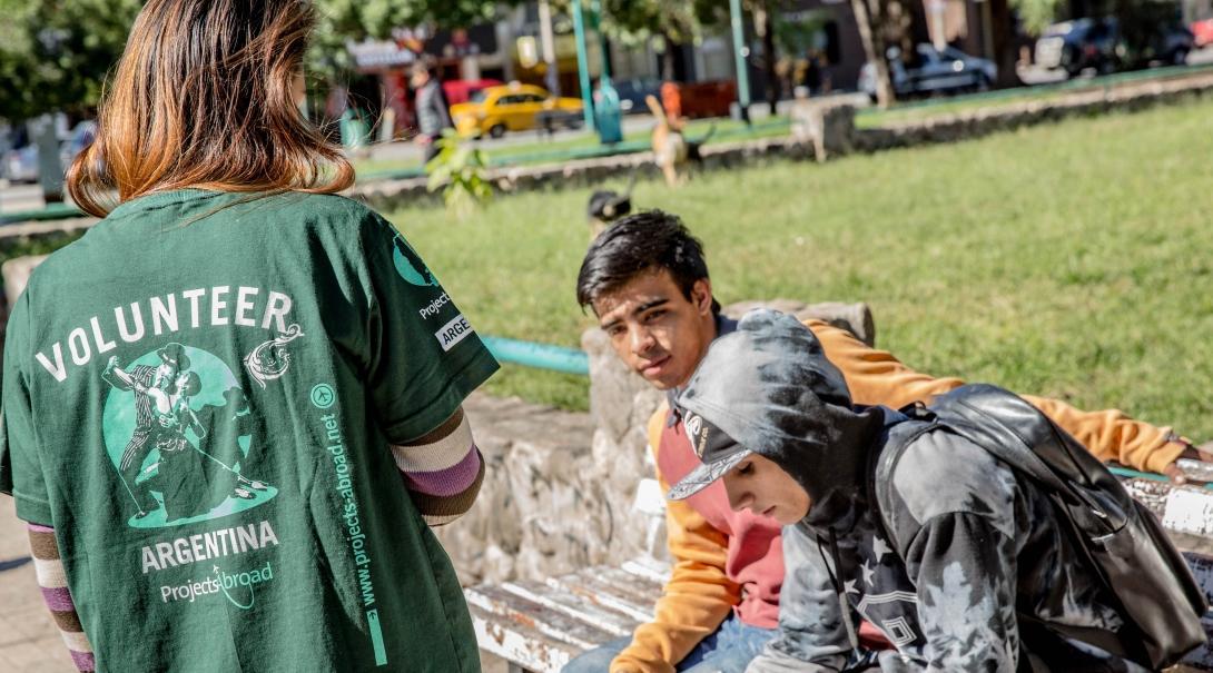 A teenager hands out flyers on her Human Rights internship in Argentina