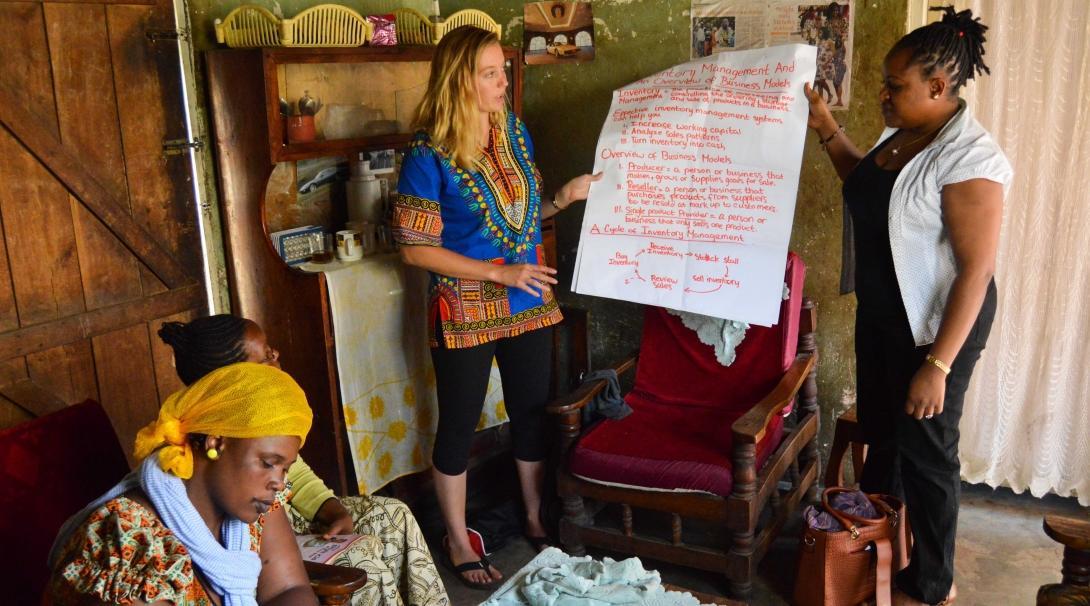 Interns gain micro-finance work experience in Tanzania by giving a presentation to small business owners