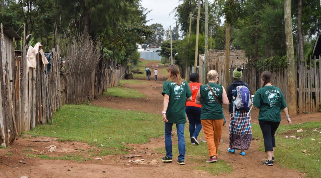 A high school student speaks to a patient on Projects Abroad's medical internship in Kenya