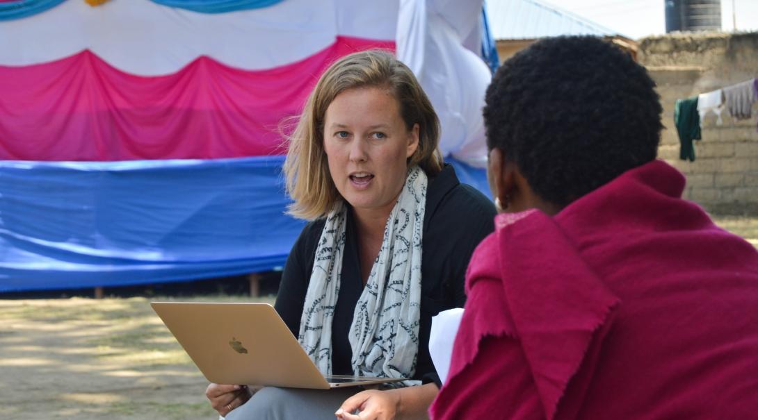 A student delivers a presentation to a local woman on inheritance during her Human Rights internships in Tanzania.