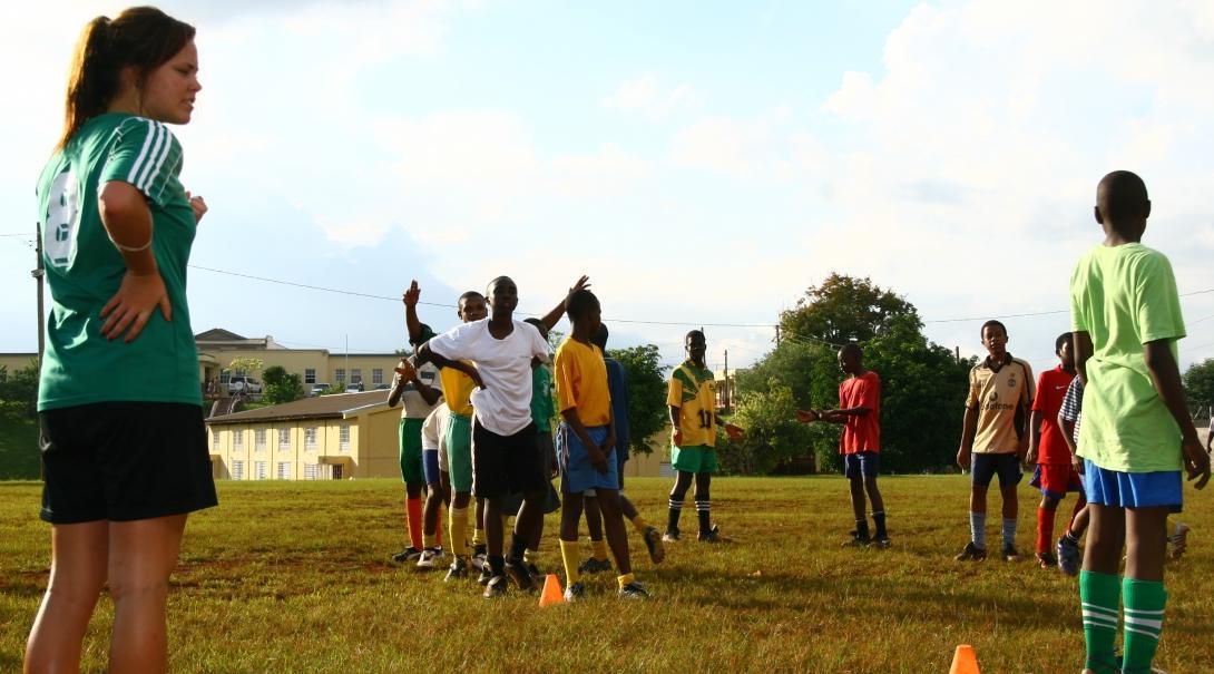 Players practise football drills through Projects Abroad's volunteer sports coaching in schools in Jamaica