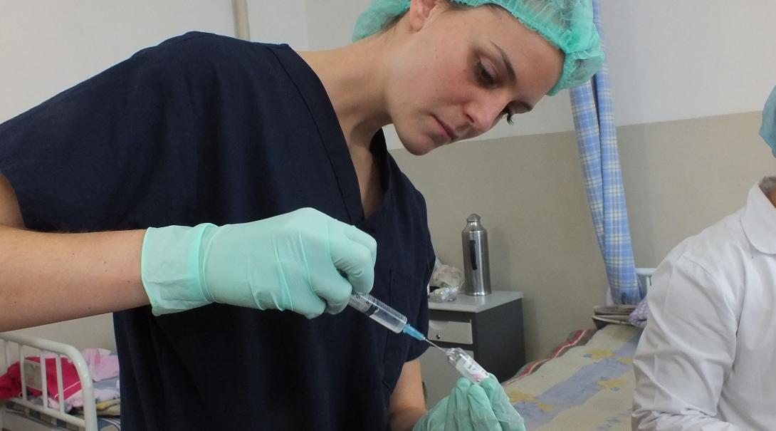 Female Medical worker uses a syringe filled with liquid in a hospital during her medical work experience in Mongolia.