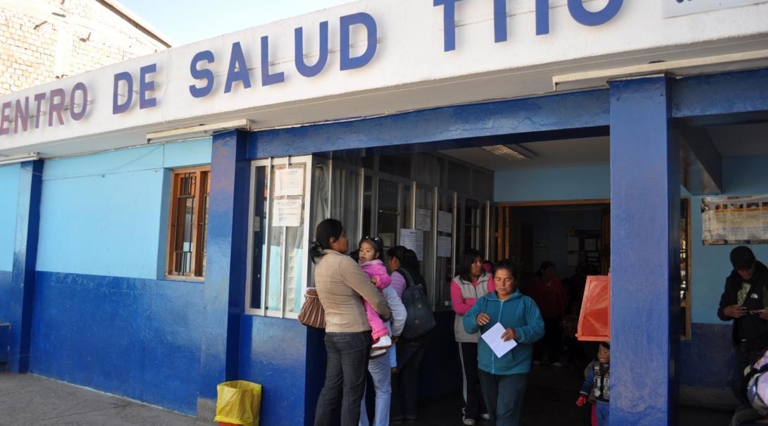 Locals are seen queueing outside a local surgery waiting to see Projects abroad interns on theri medical internship in Peru.