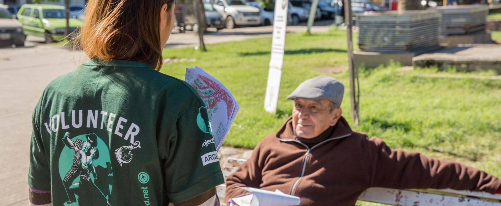 A student speaks to a local man during a campaign on her Human Rights internship in Argentina.