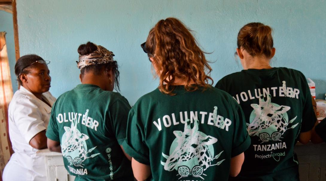 Three interns help to prepare medication whilst on their medical internship in Tanzania with Projects Abroad