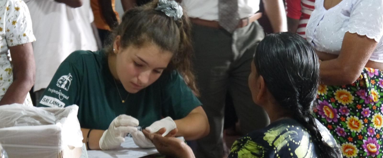 An expecting mother has a health check done by a Projects Abroad Midwifery intern in Sri Lanka.