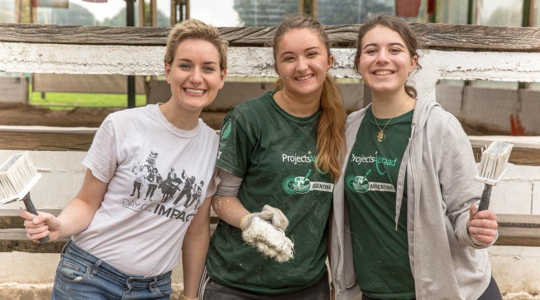 While learning Spanish in Argentina, students volunteer at a local school and help with painting work. 