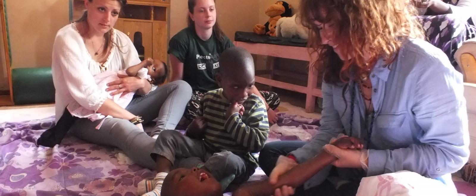 Projects Abroad Intern taking part in a busy physiotherapy session whilst on her occupational therapy internship in Kenya.