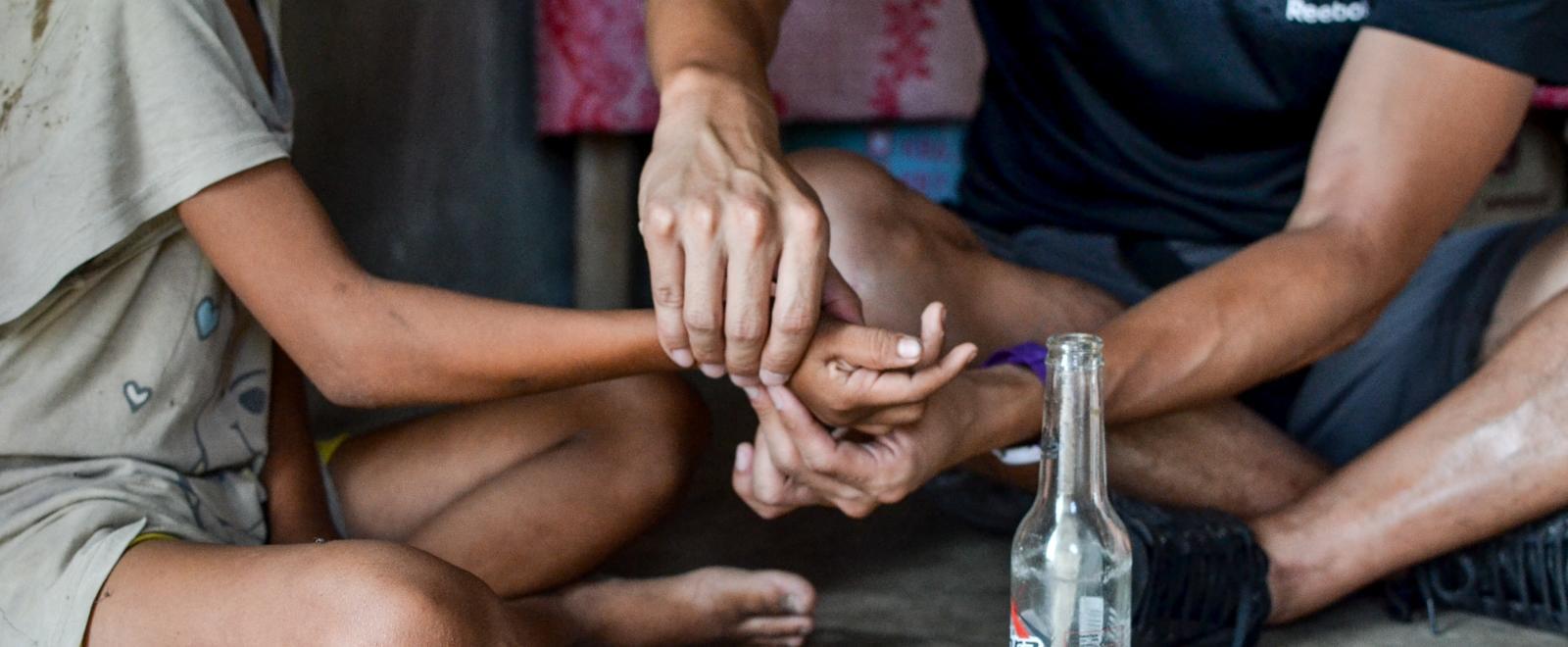 Projects Abroad intern is seen gaining valuable work experience whilst giving physiotherapy to a local child during his physiotherapy internship in the Phillippines.