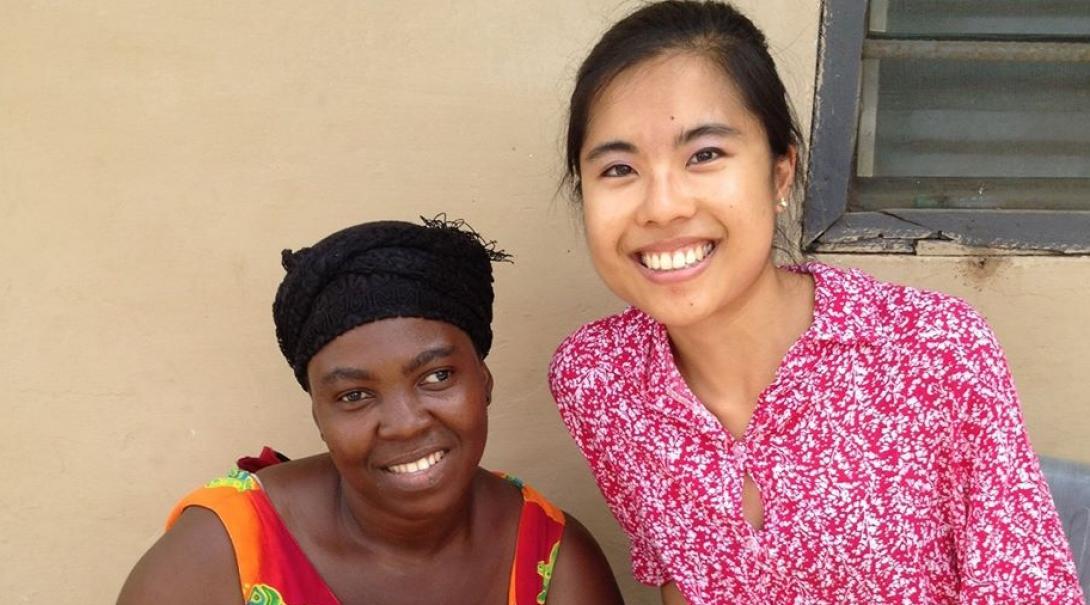 A female intern from Projects Abroad is pictured with a local woman and her child whilst on her speech therapy internship in Ghana.