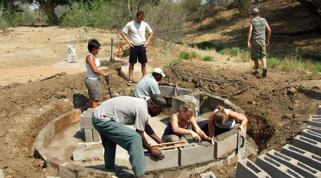 Volunteers from Projects Abroad are seen helping with landscaping jobs as part of their wildlife conservation work oppurtunity in Botswana.