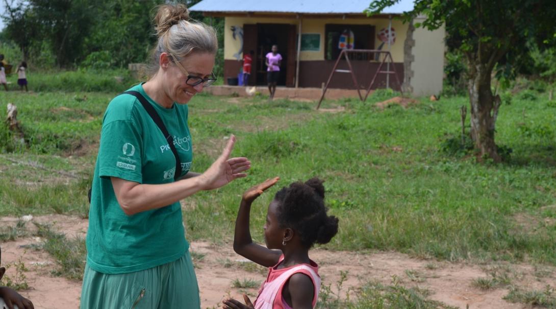 In Ghana, a young girl and intern play a game after a speech therapy session. 