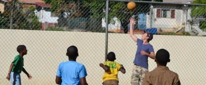 Students learn the basics of basketball during volunteer sports coaching in schools in Jamaica