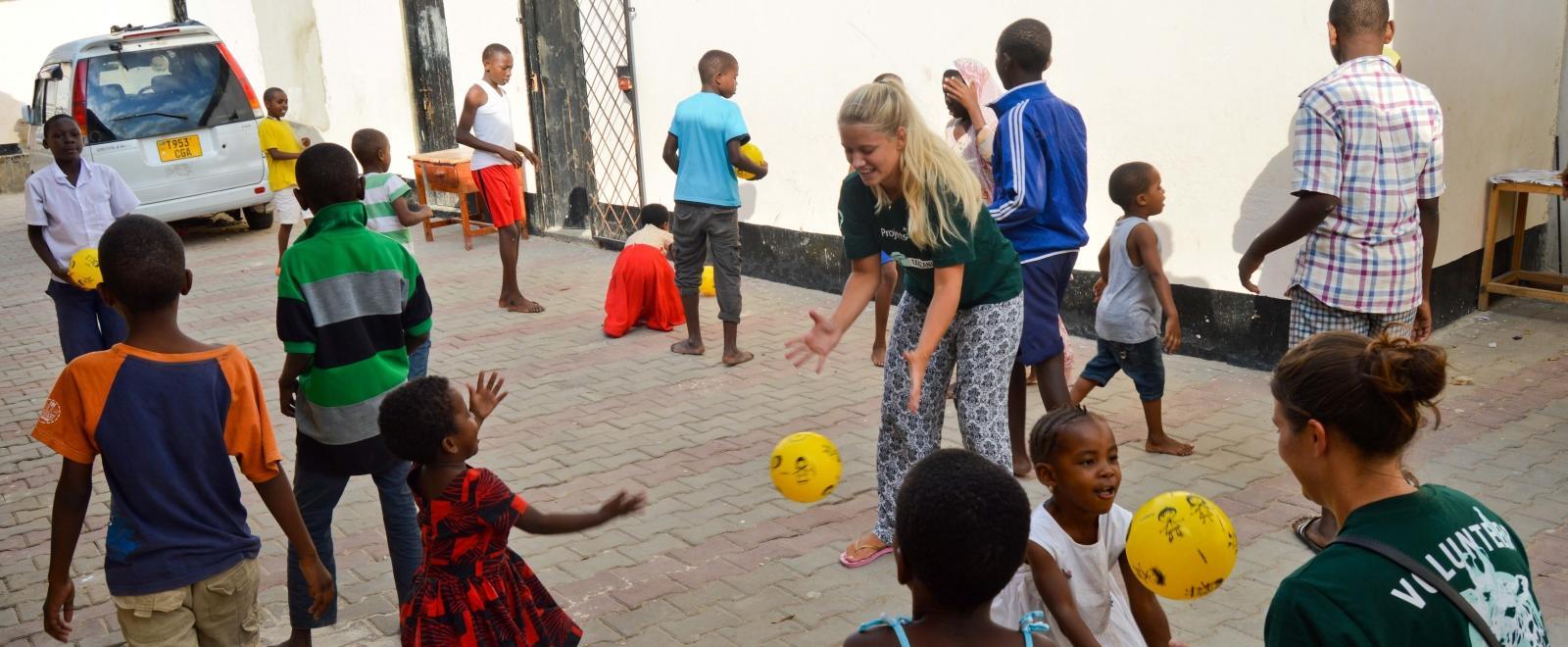 Projects Abroad volunteers play ball sports with children in Tanzania on our placement for teenagers