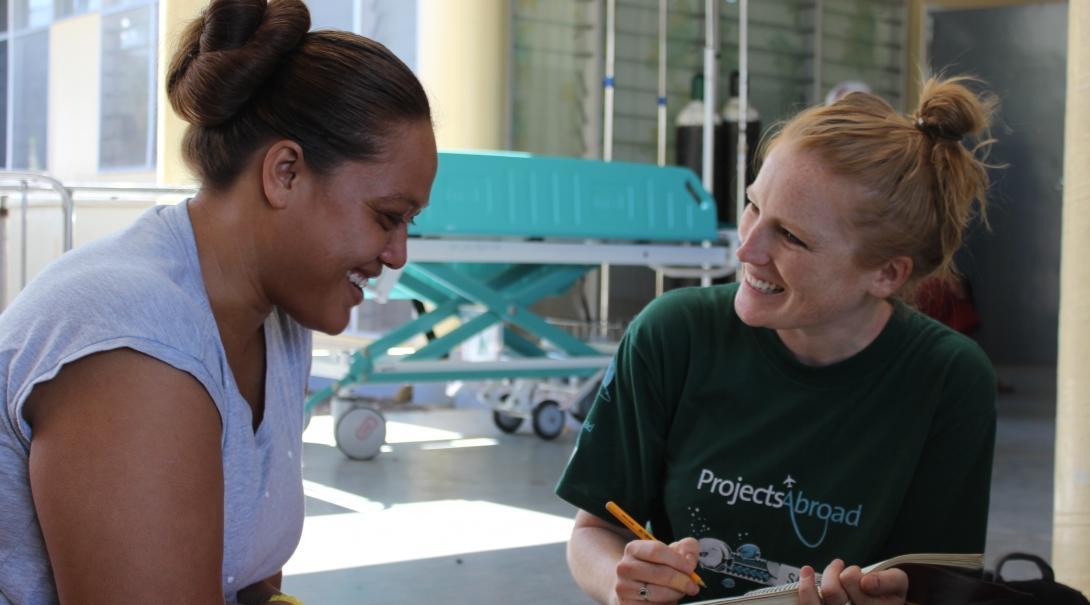 A local woman chats about her dietary choices and lifestyle with a student doing a Nutrition internship abroad in Samoa.