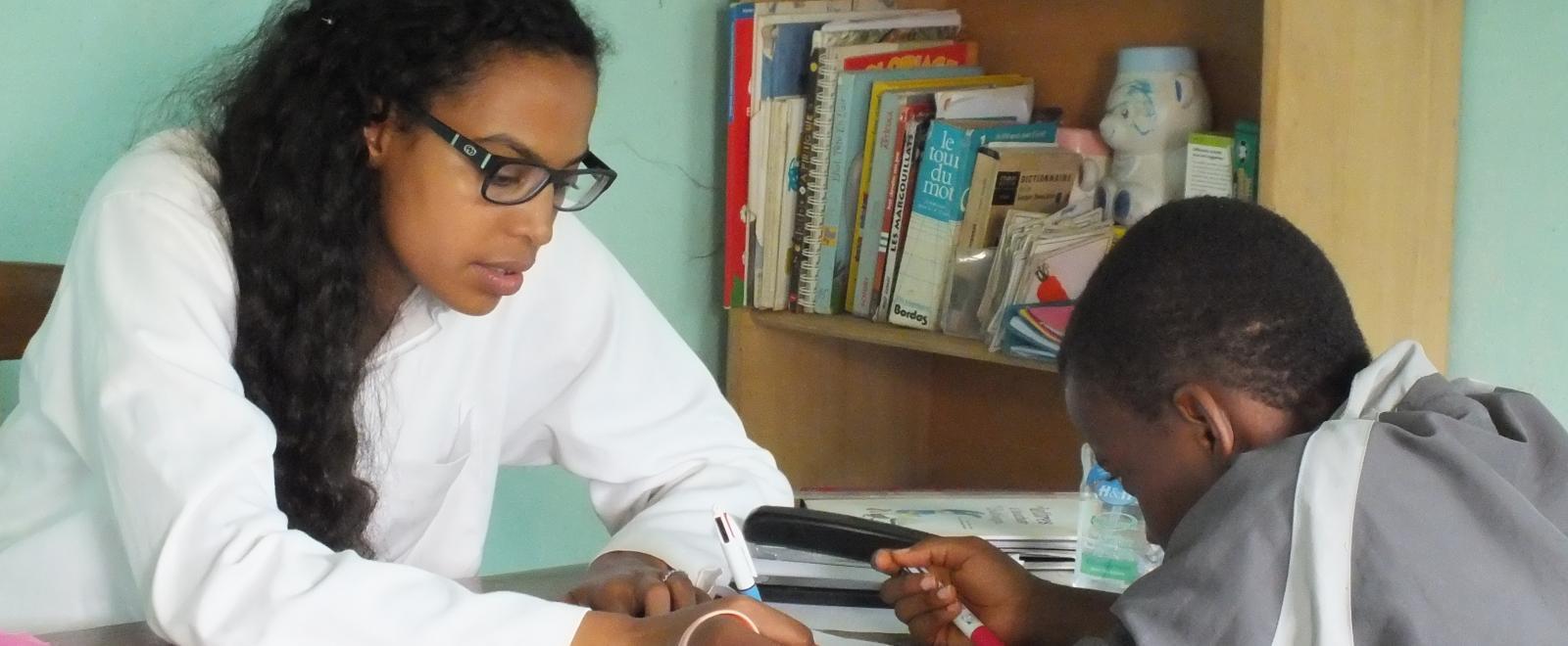 A local child is treated by a student doing a Speech Therapy internship abroad in Africa.