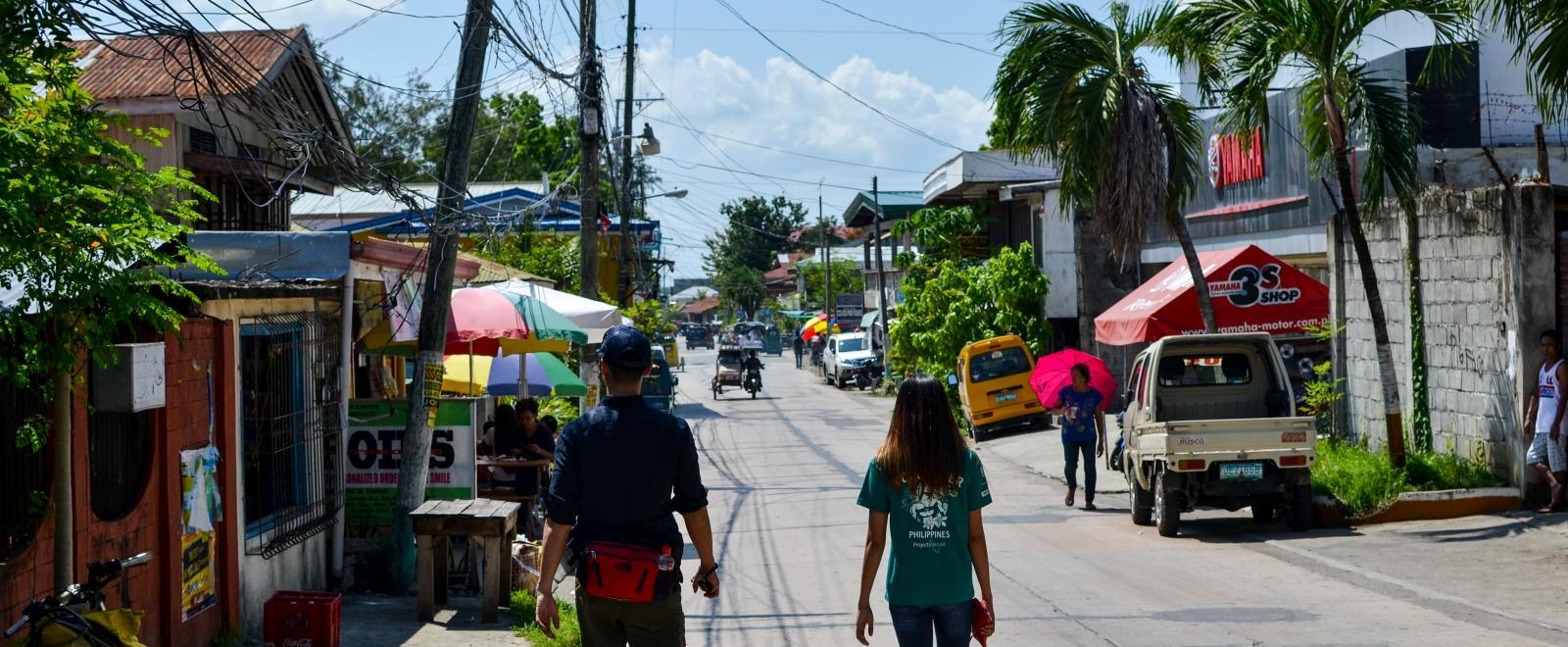 A staff member takes a volunteer on her Projects Abroad induction in the Philippines.