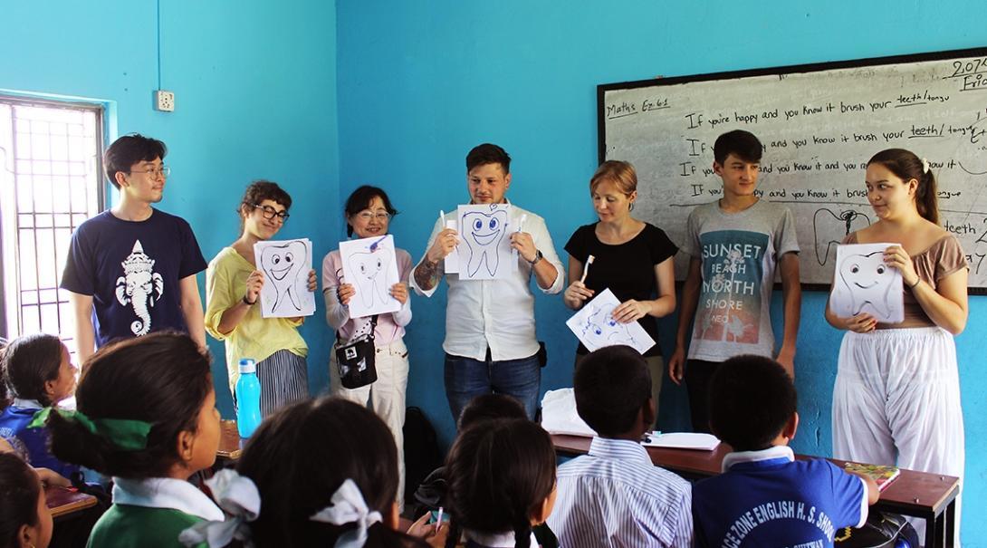 A group doing medical internships in Nepal help teach young children about oral hygiene at a local school. 