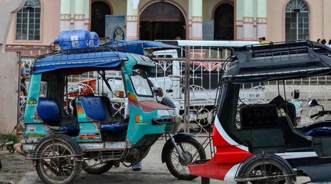 Trike drivers parked outside a roman catholic church in Bogo City