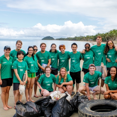 A group of Projects Abroad volunteers assist with a beach clean-up initiative where no experience is needed to volunteer overseas.