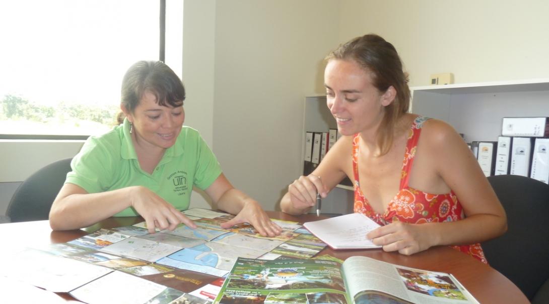 The Spanish teacher helps her student practice by getting her to read Spanish magazines in Costa Rica