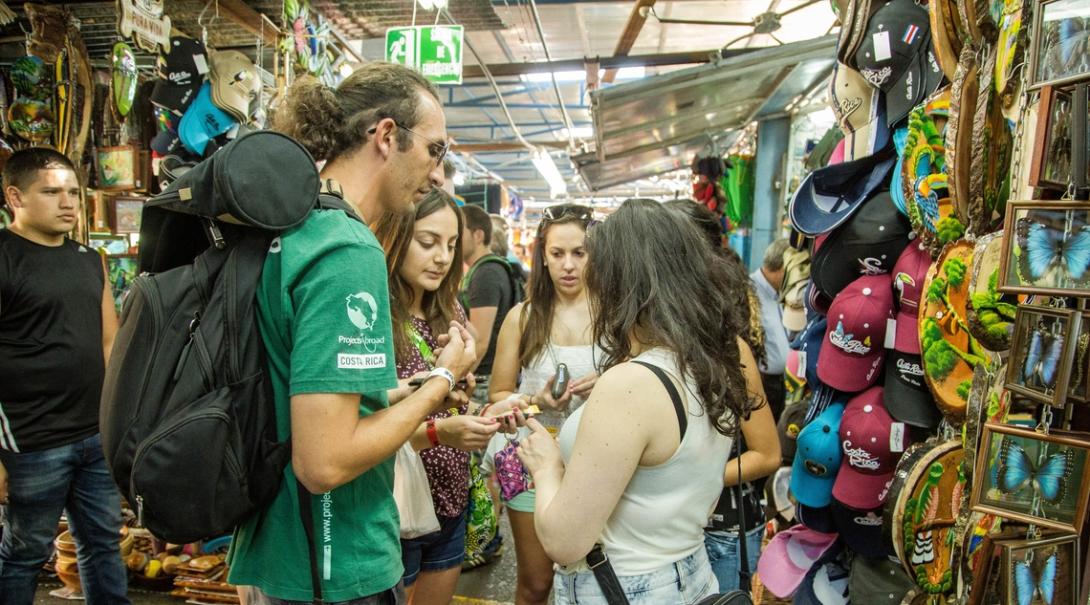 A volunteers talks to the locals at a market as part of his Spanish course in Costa Rica