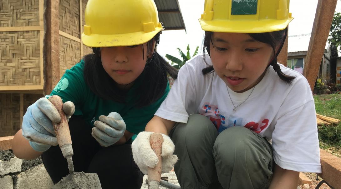 Two Projects Abroad volunteers building a house on one of our best volunteer abroad programs.