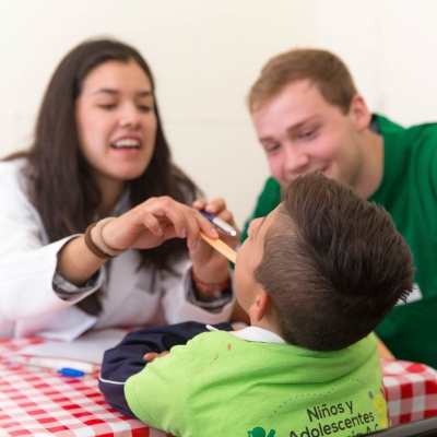 An intern checks a woman’s blood pressure during an undergraduate medical volunteering opportunity abroad.