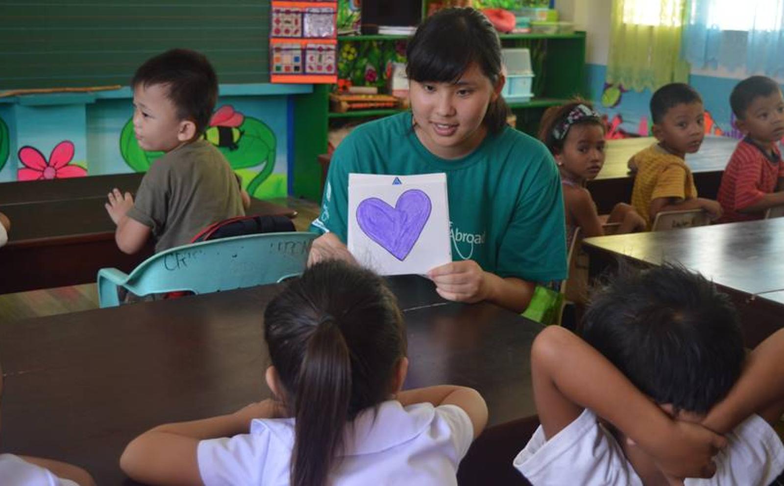 A Japanese Childcare volunteer teaches students about shapes on the Childcare project in the Philippines