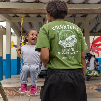 A childcare volunteer in Ecuador supervises children during playtime