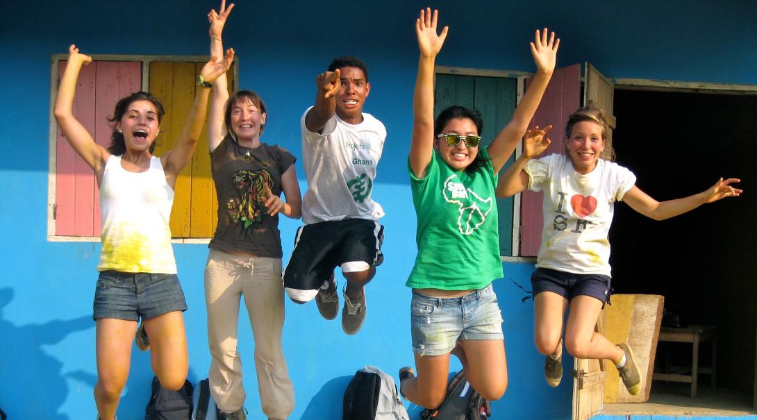 Group photo of volunteers after painting a local school in Ghana during their community volunteer work for teenagers.