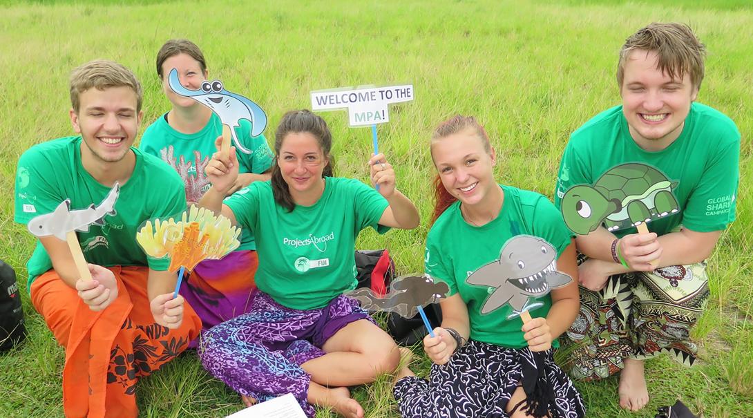 Projects Abroad Shark Conservation volunteers prepare material for an awareness campaign in Fiji.