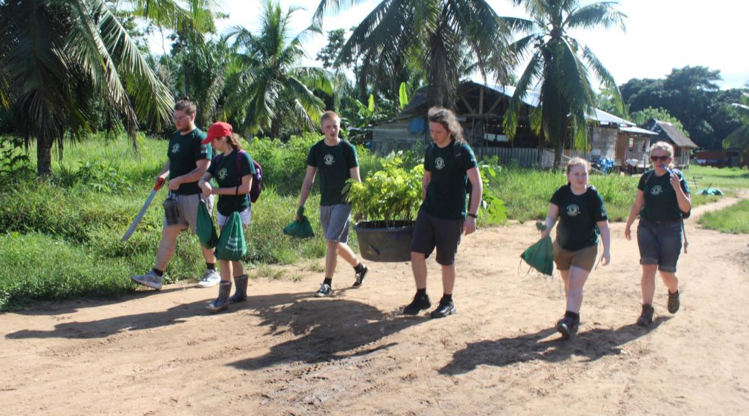 Projects Abroad volunteers take materials to the farm as part of the conservation work in the Amazon Rainforest in Peru.