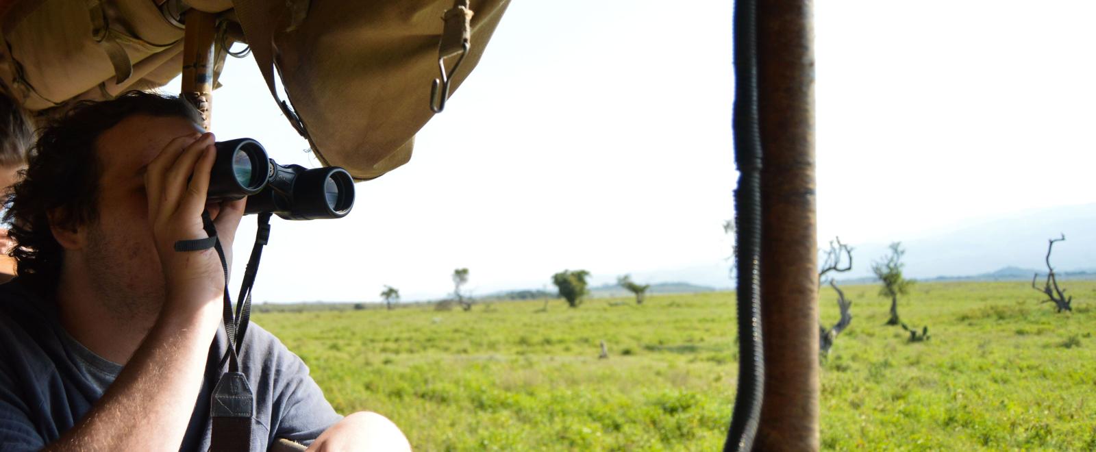 Conservation intern spots a giraffe during his wildlife survey in Kenya.