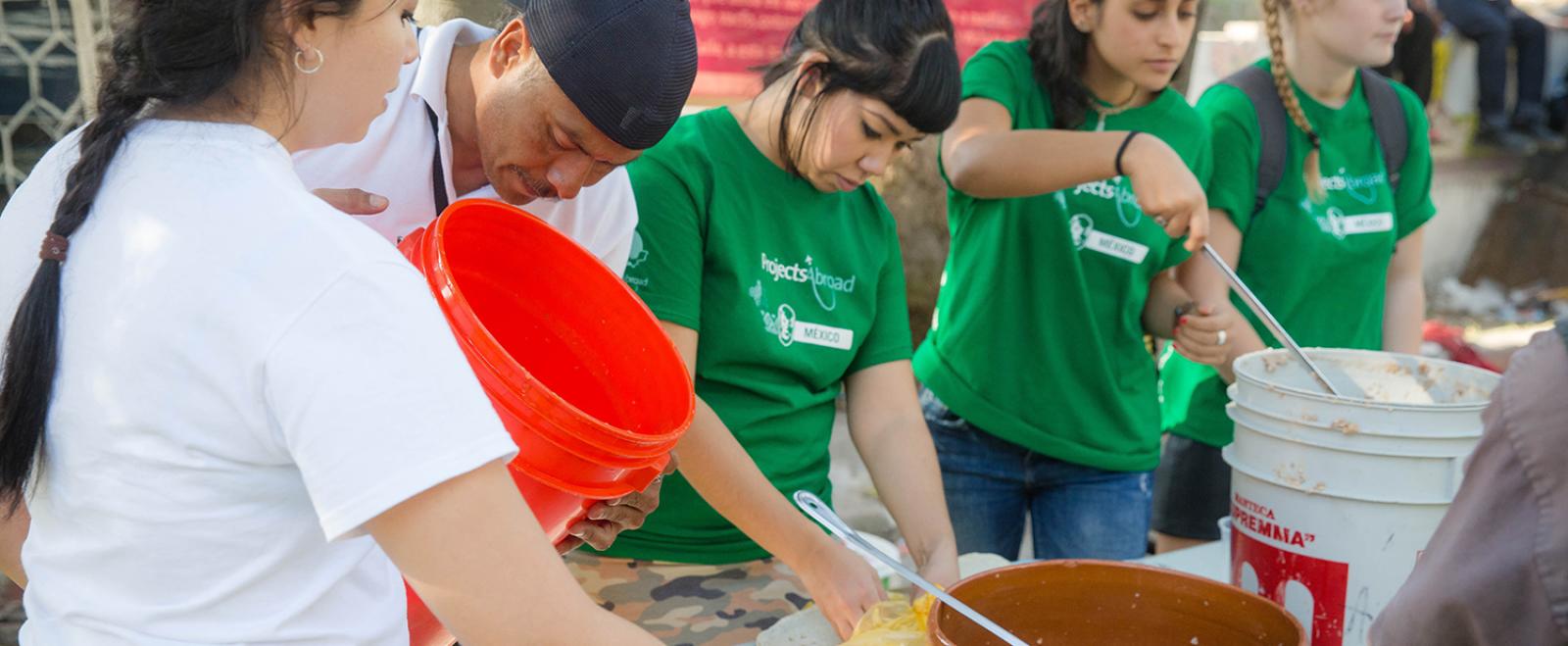 Refugee support volunteers serving food during meal time in Mexico.