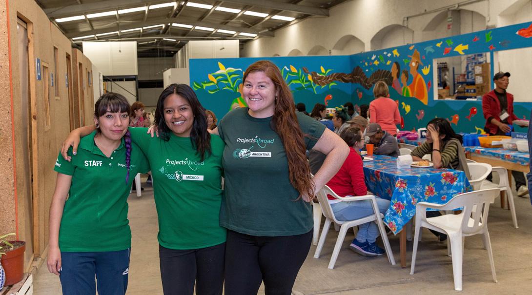 Refugee support volunteers and staff take a photo at the refugee center in Mexico.